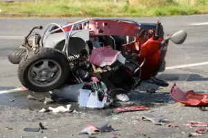 A crushed motorcycle after a head on collision.
