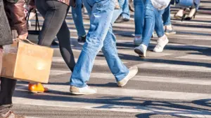 A pedestrian crosswalk where people are crossing it.