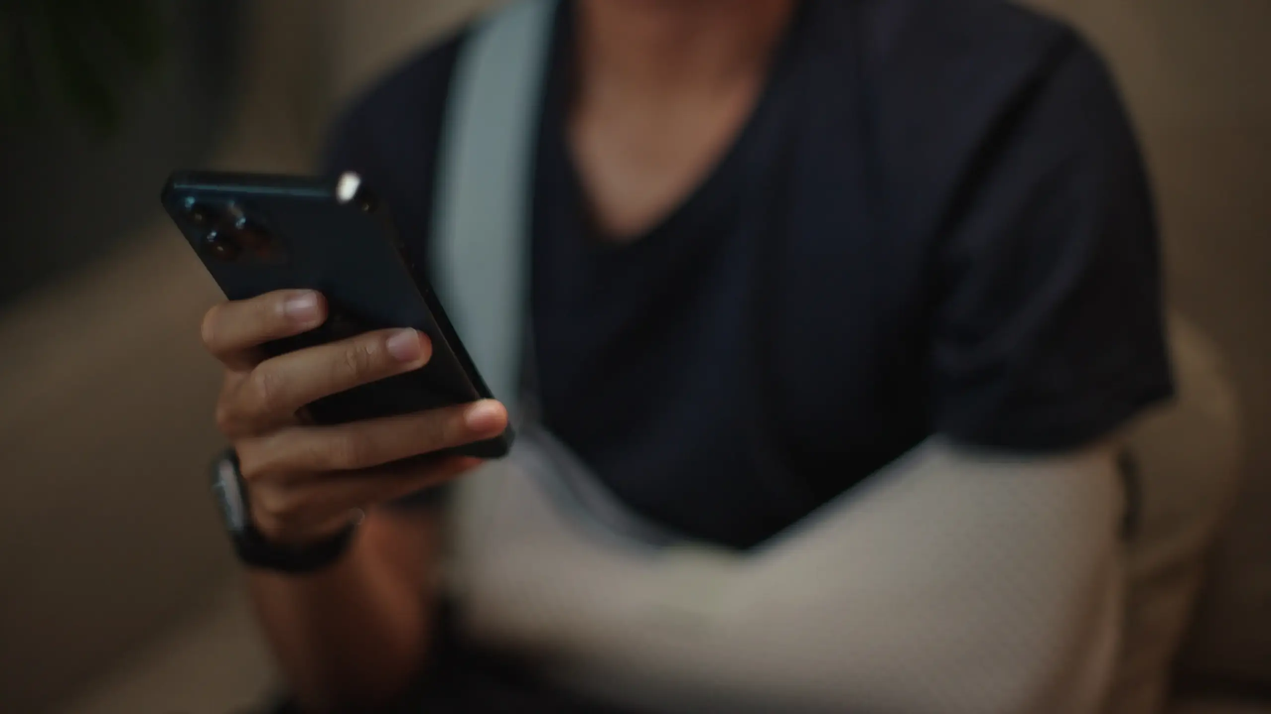 A person with a broken arm on their phone.