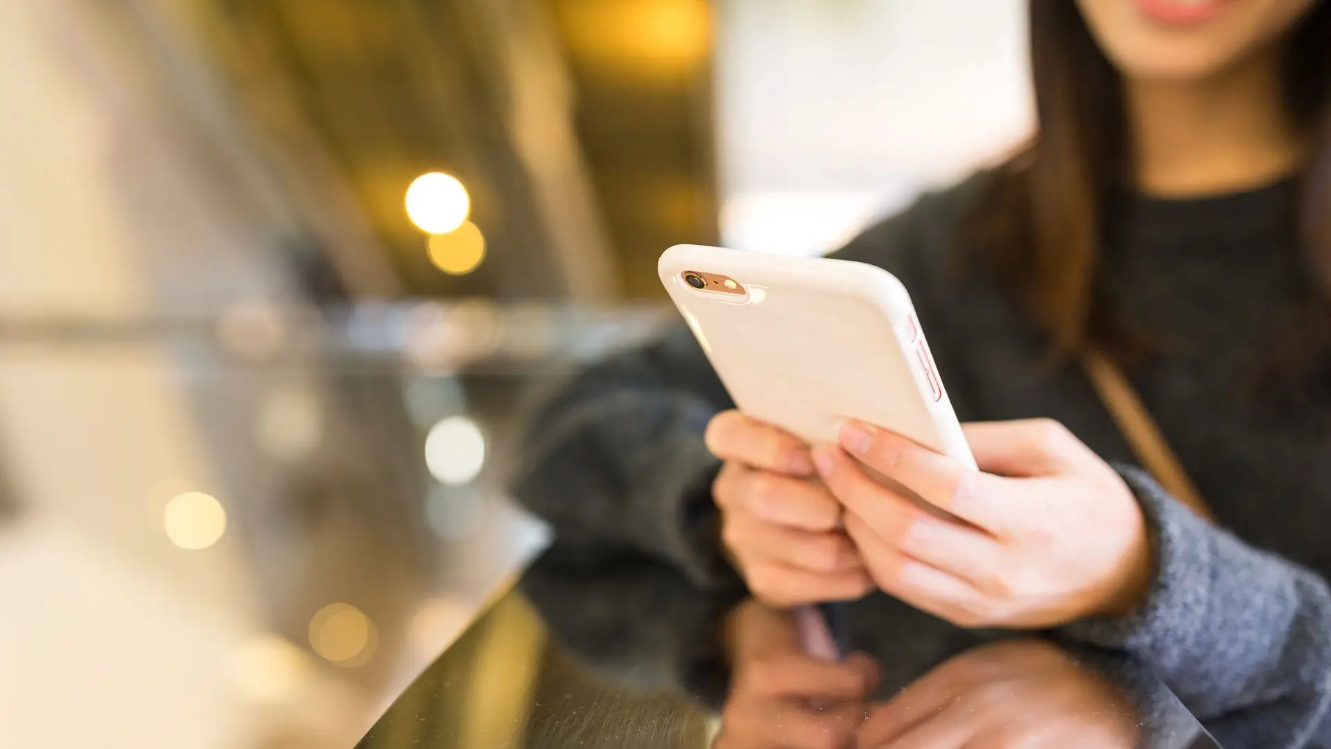 A woman on her phone looking up information.