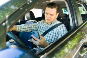 A concerned man looking at his phone. 