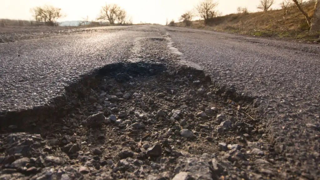 A pothole in the middle of a road. 