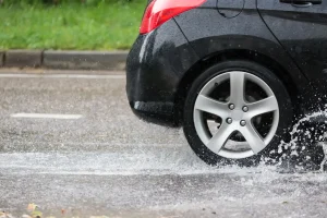 A shot of a car driving through rain.
