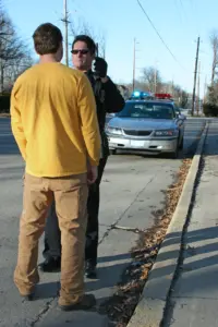 A man taking a sobriety test with an officer.