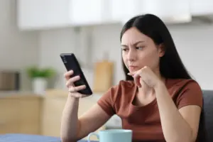 A woman looking up deposition tips on her phone.