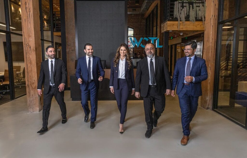 Attorneys from West Coast Trial Lawyers walking through their law firm's lobby.