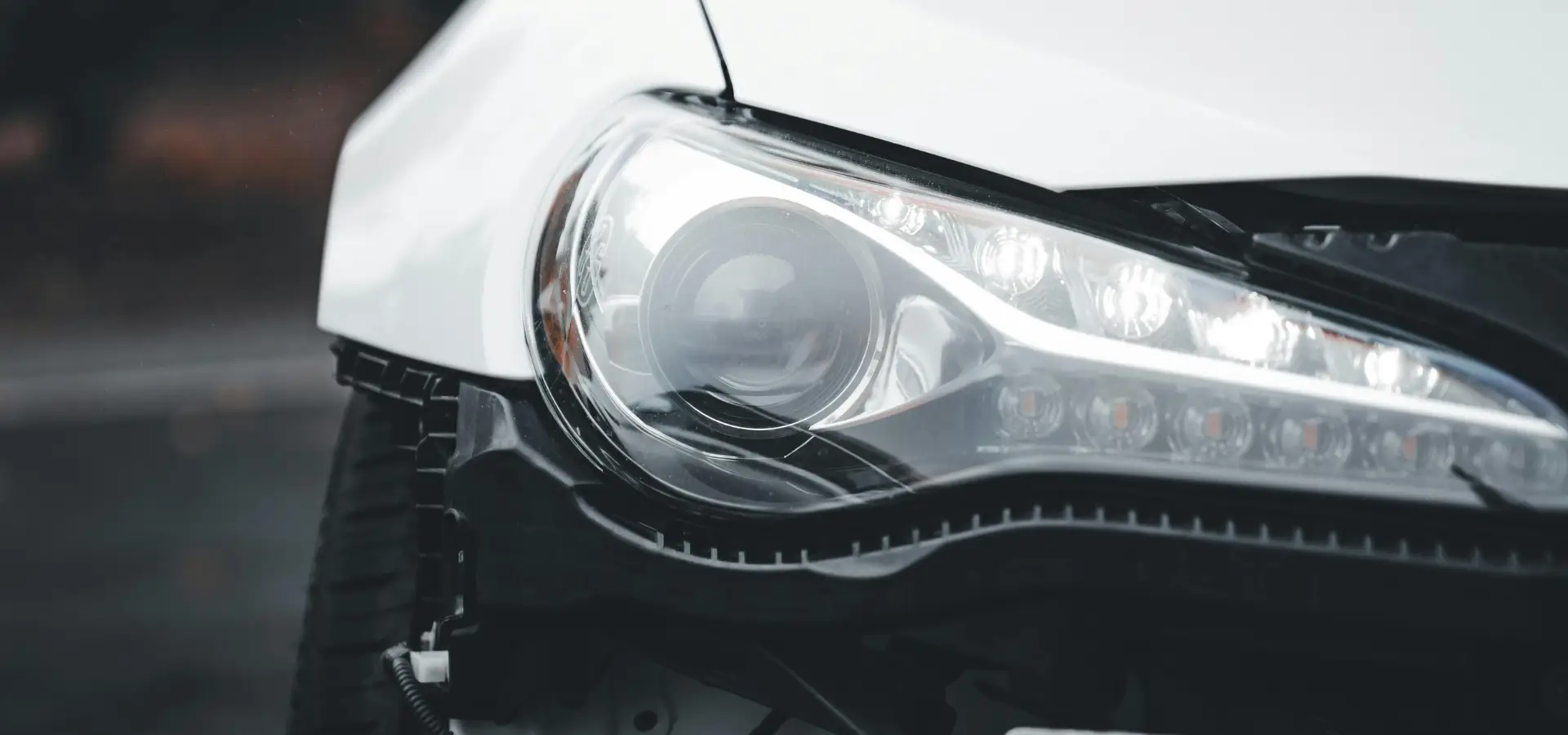A broken headlight of car.