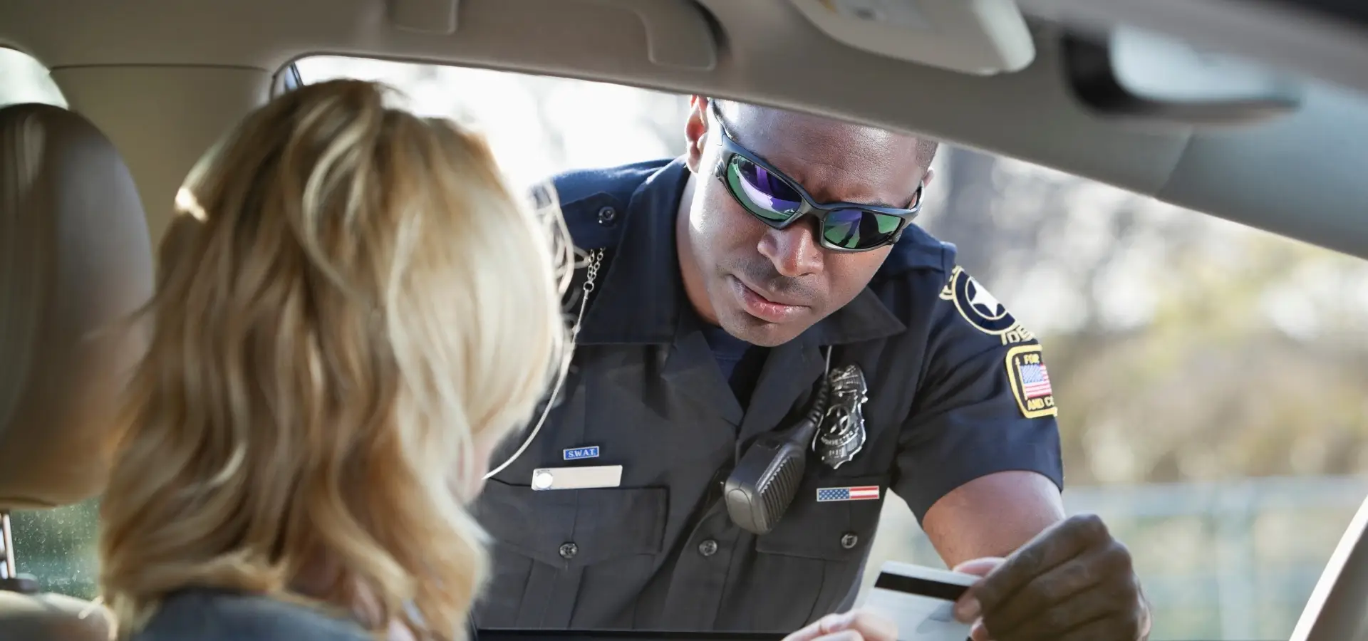 A police officer checking a driver's license.
