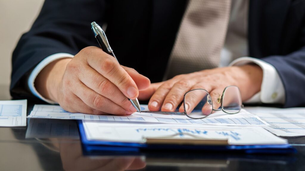 Personal injury attorney writing out a check for his client.