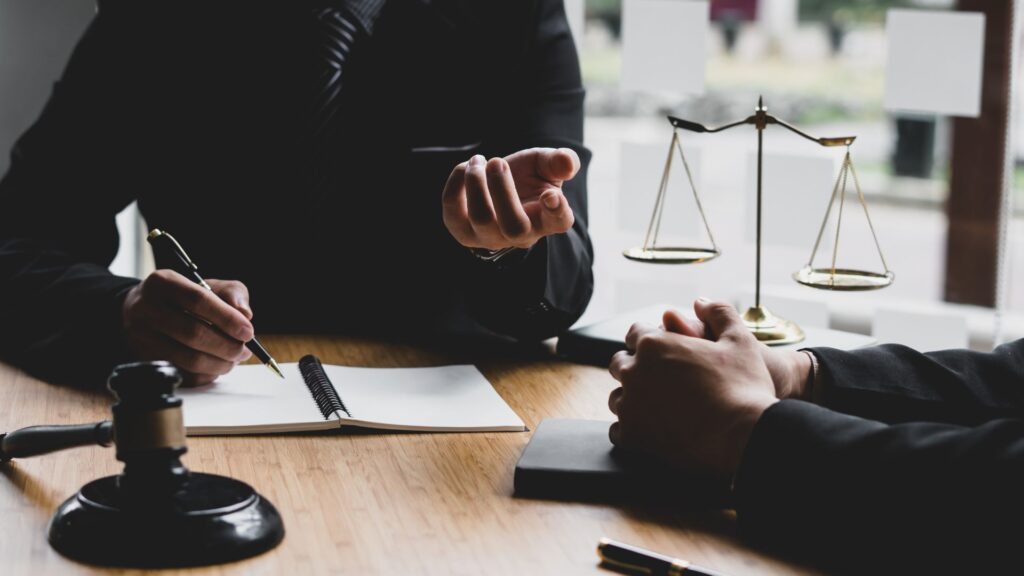 Personal injury attorney meeting with client to discuss case matters.