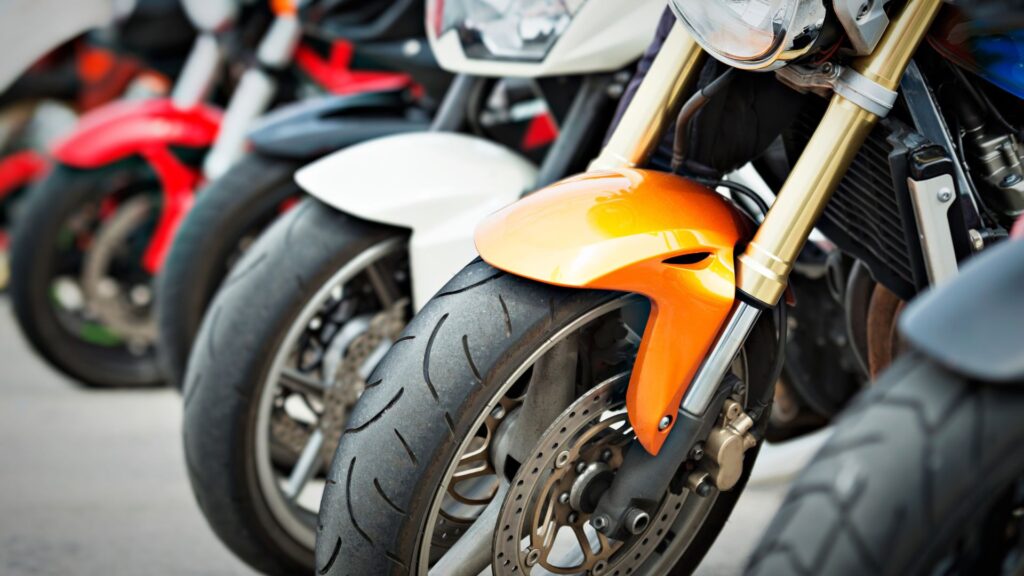Close up of motorcycles lined up in a row.