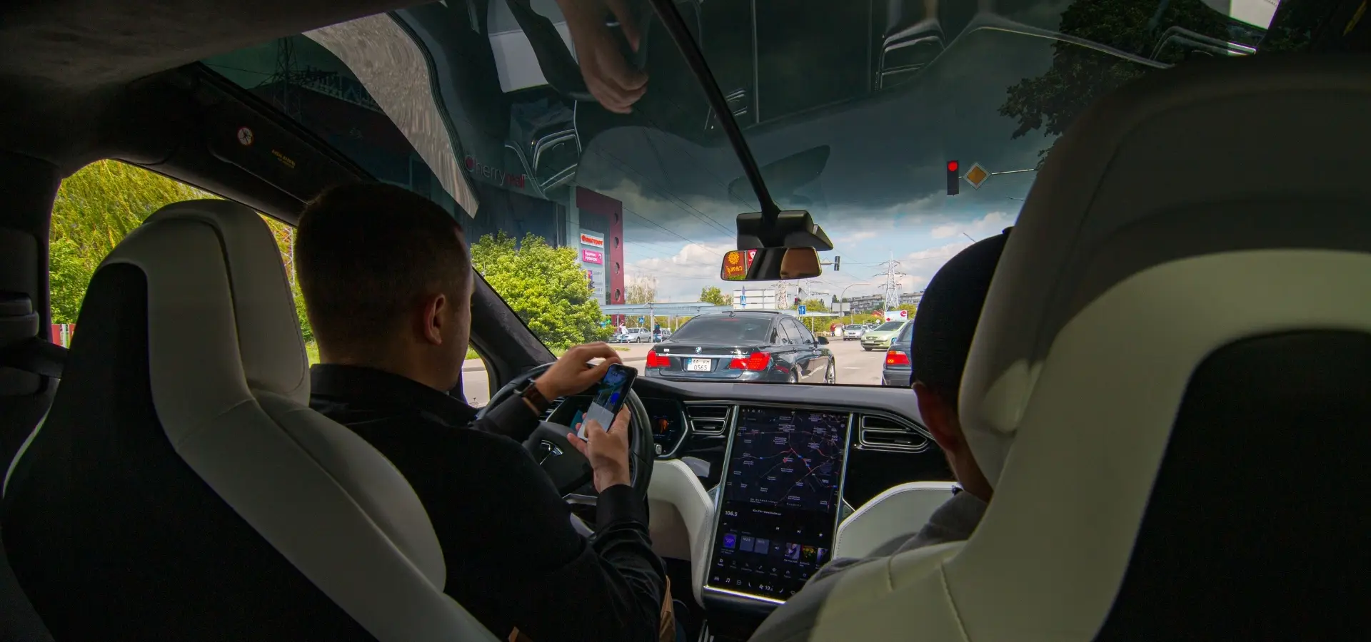 An Uber Driver using his phone during a trip.