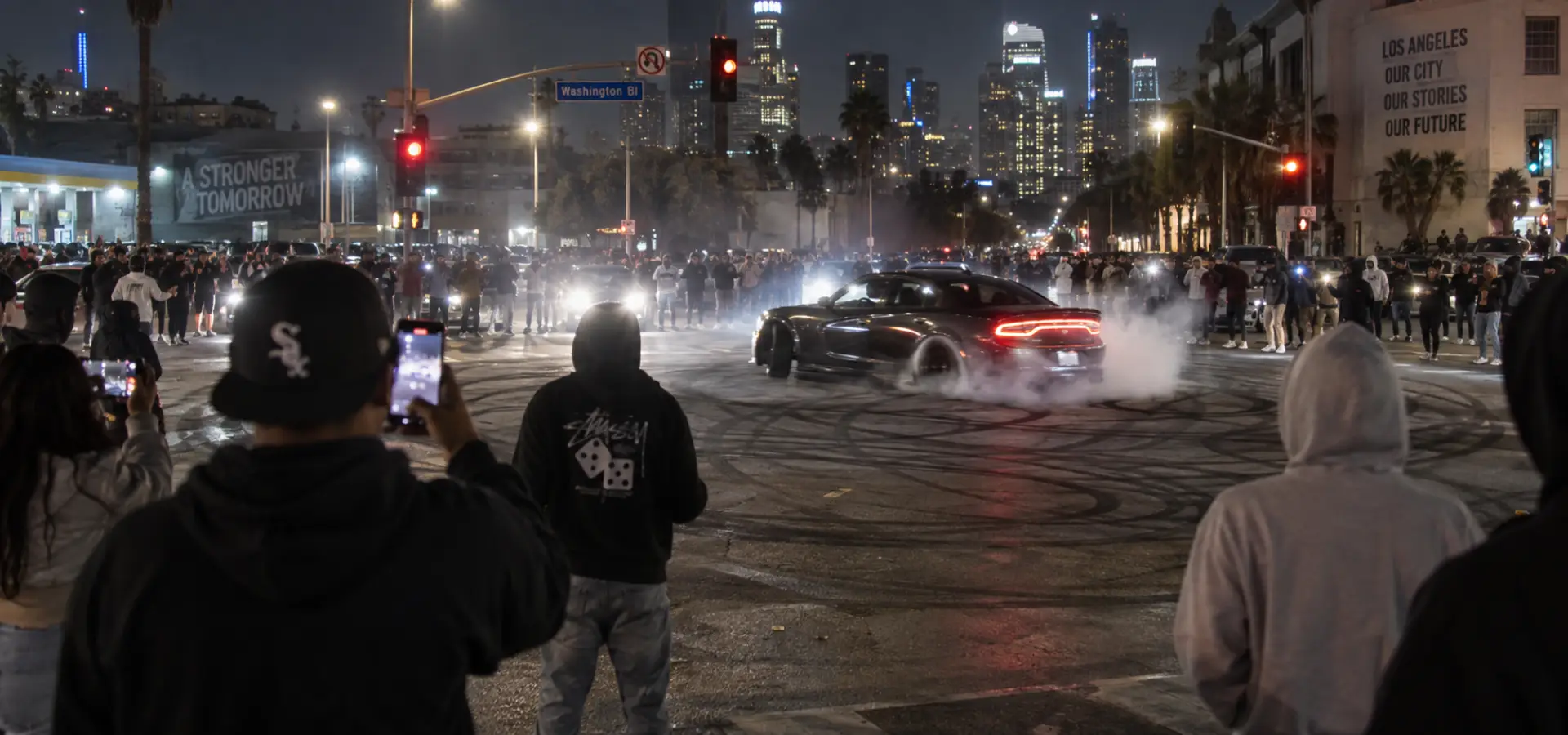 A street takeover happening in the middle of an intersection.