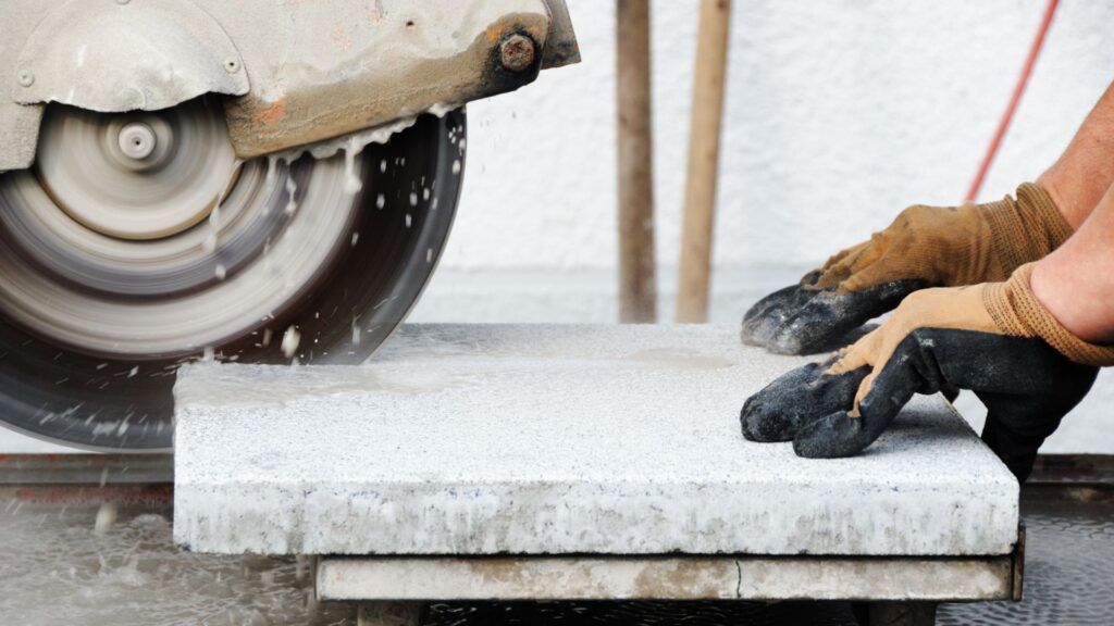 A person cutting a countertop counter with a powersaw.