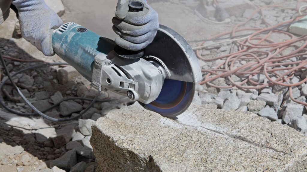 A person cutting stone with an industrial saw.