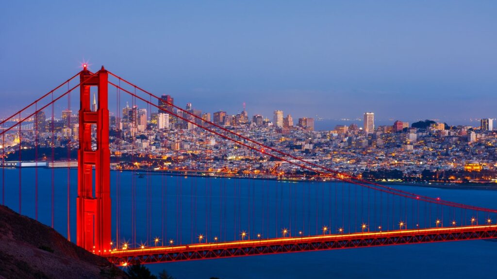 The Golden Gate Bridge with a city skyline in the background.