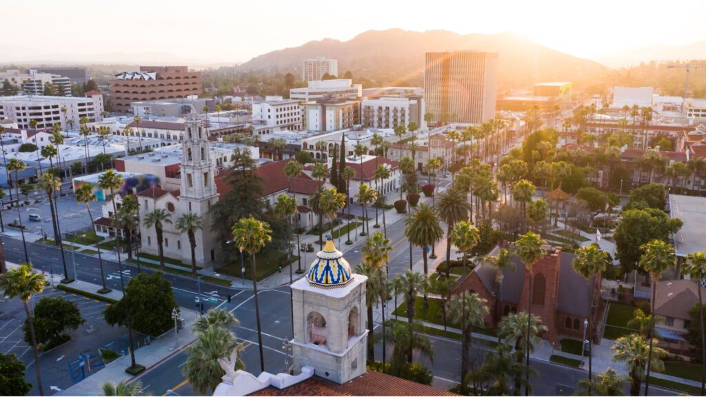 A view of a California city with the sun setting in the back.