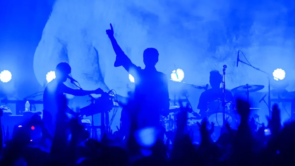 A band is playing at a show for a crowd of people.