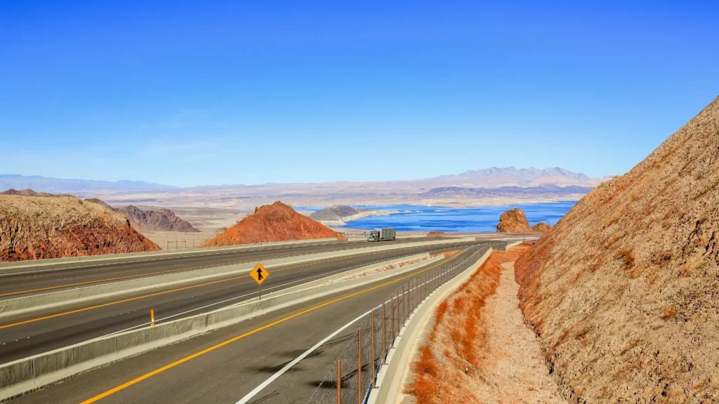 A large open road with a basin and a truck in the distance.