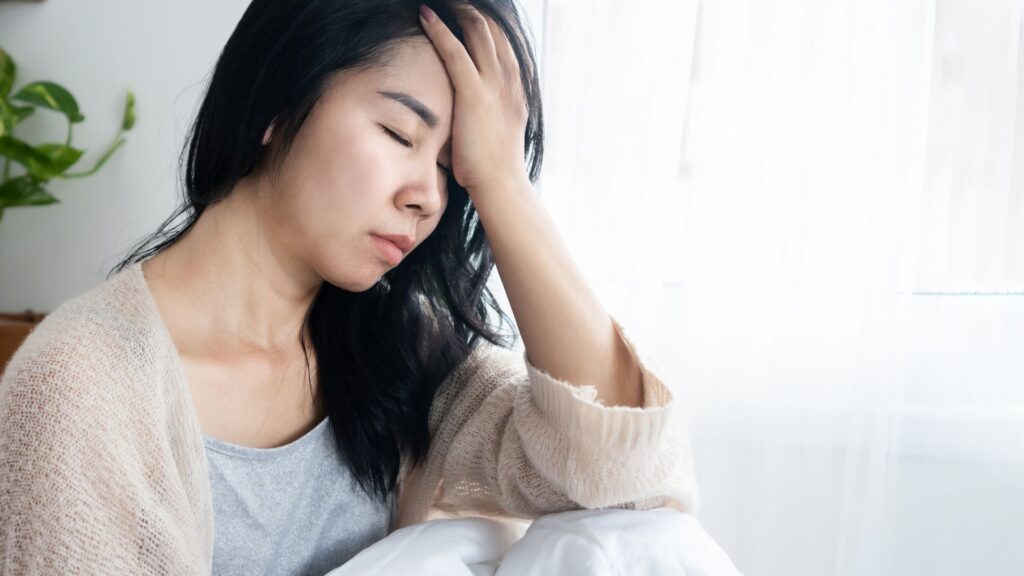 A woman who has a headache.