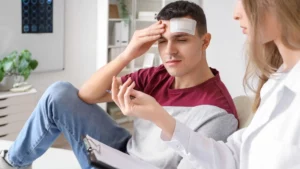A man with a head injury getting an explanation by his doctor.