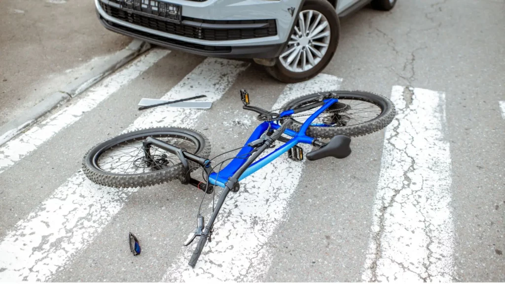 A bike accident on the middle of the road.