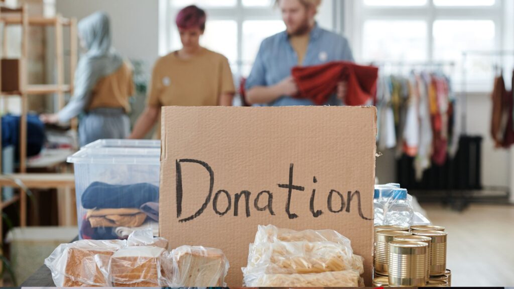 A donation box filled with food, clothes, and other supplies.