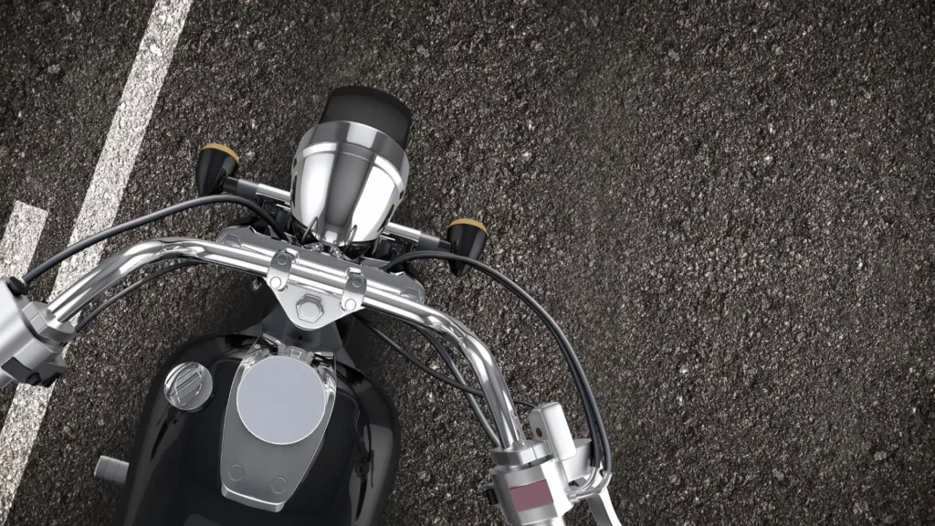 A top shot of a motorcycle driving down the road.