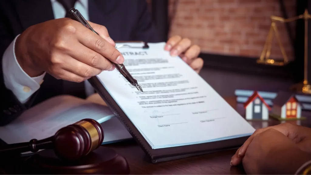 A lawyer asking their client to sign a document.