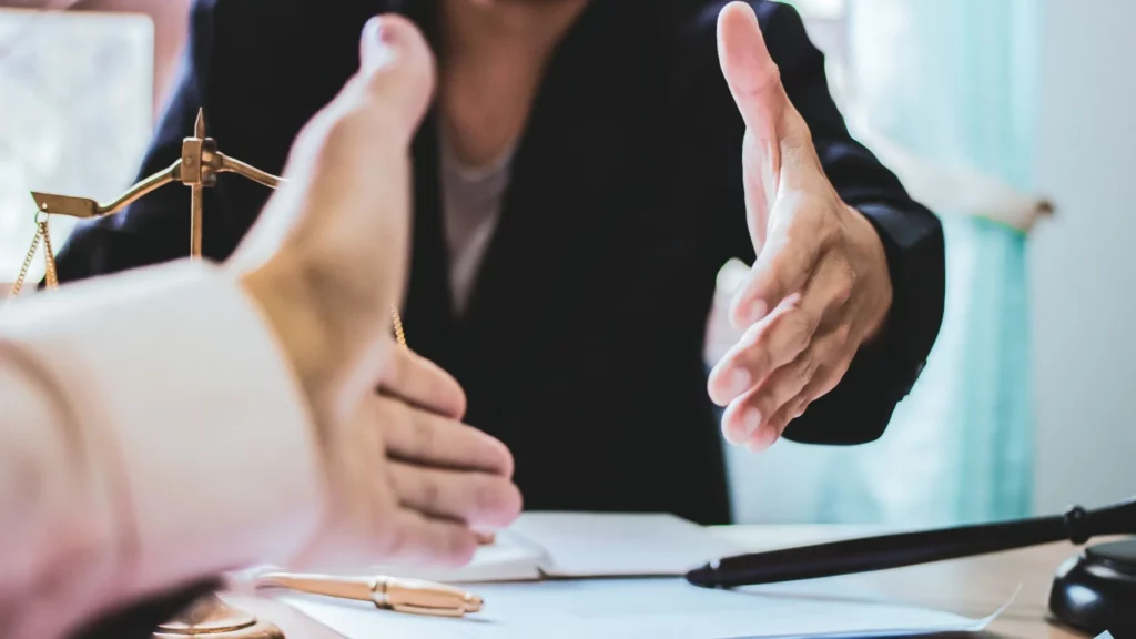 Two lawyers going to shake hands for an agreement.