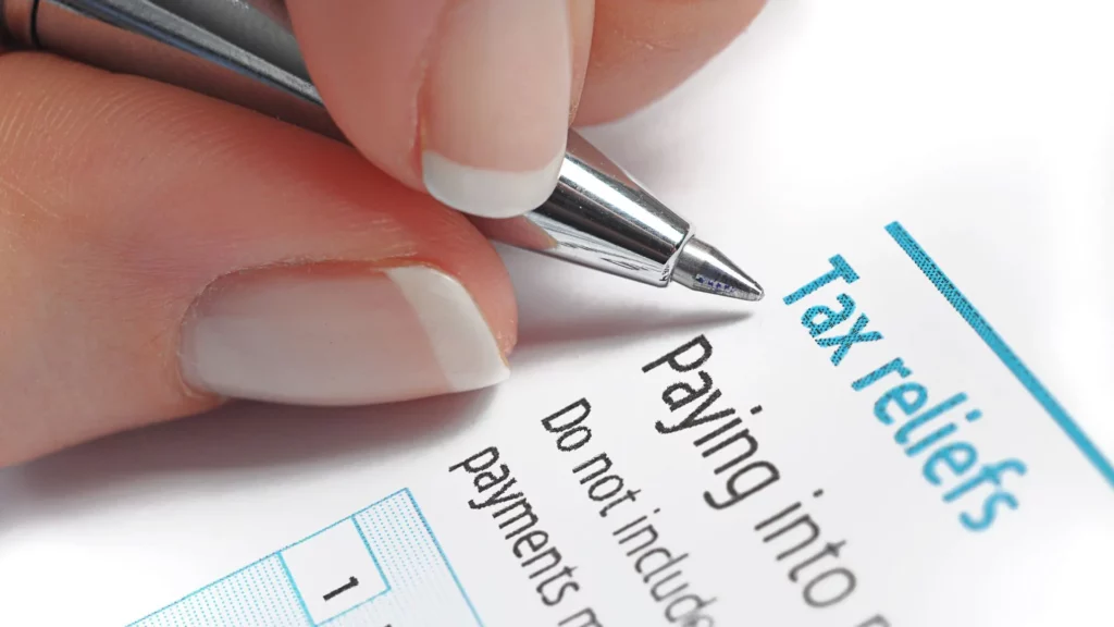 A person filling out a tax relief application.
