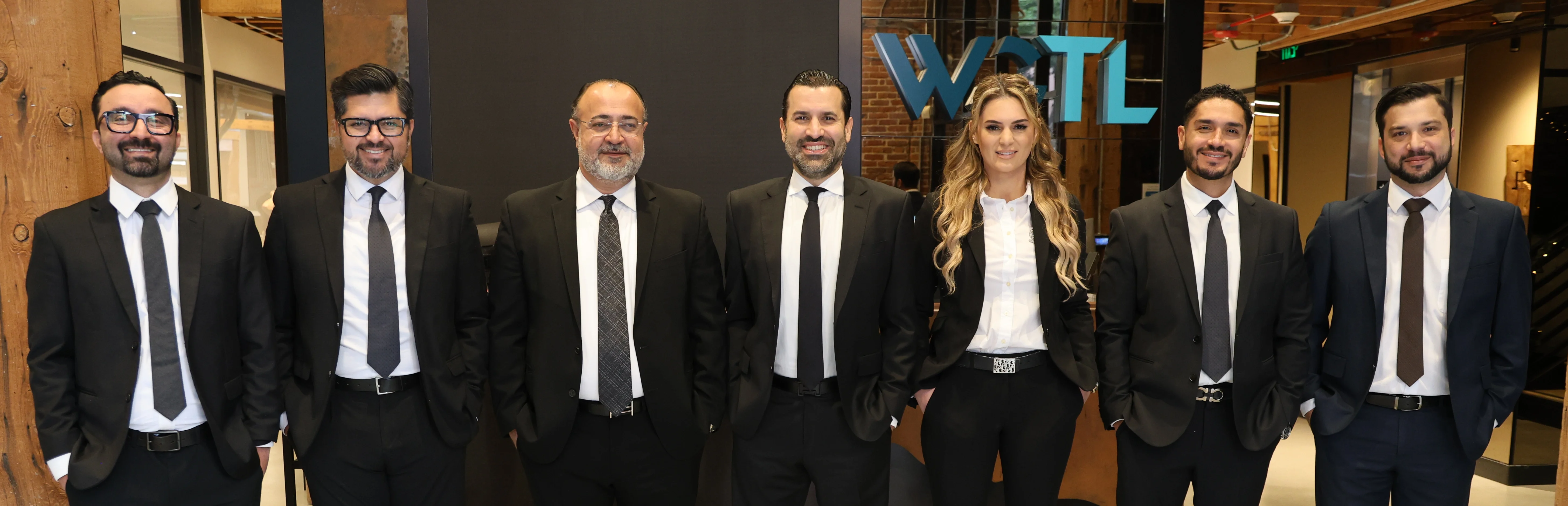 A row of attorneys from West Coast Trial Lawyers.