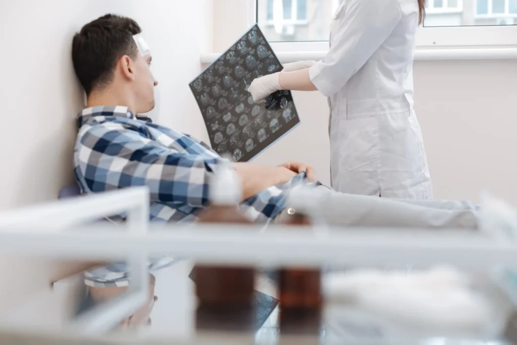 A man getting shown his brain x-ray by his doctor.