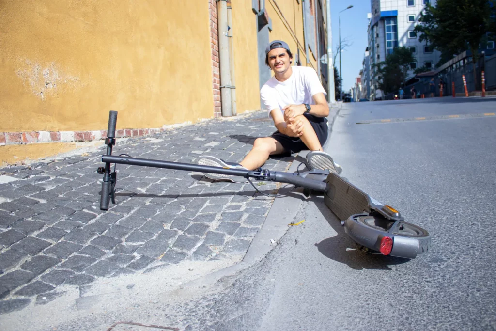 A man fallen from an electric scooter accident.