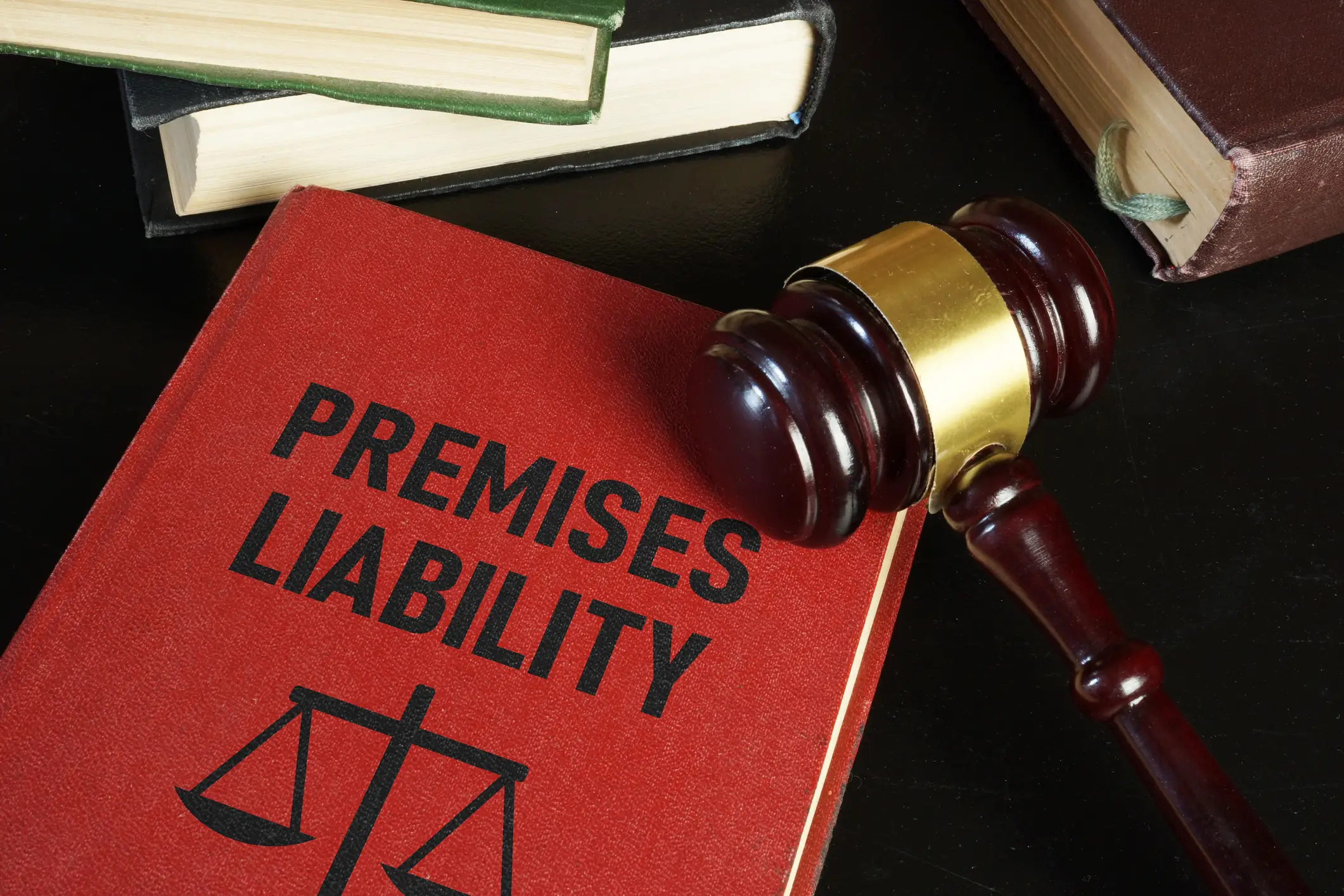 A red book titled 'Premises Liability' with a gavel placed on top.
