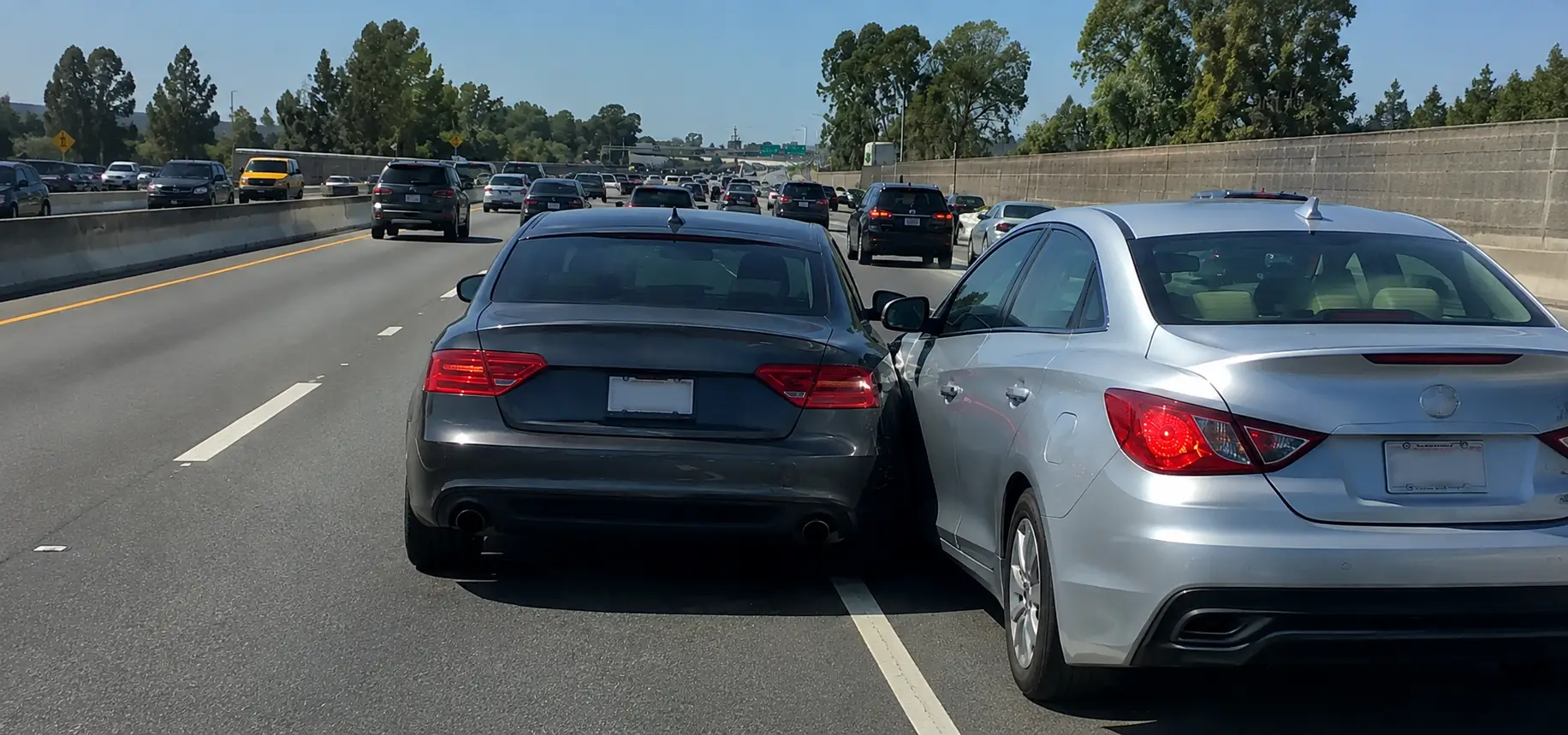 A merging accident where one car crashes into another because they didn't check properly.