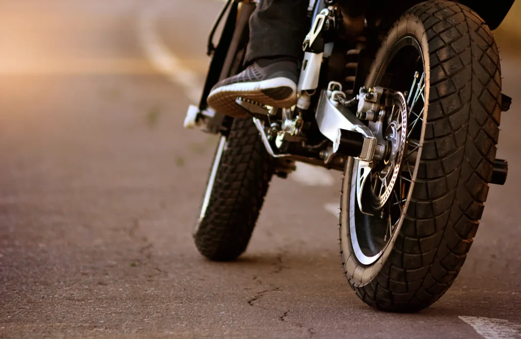 A motorcycle driving down a road.