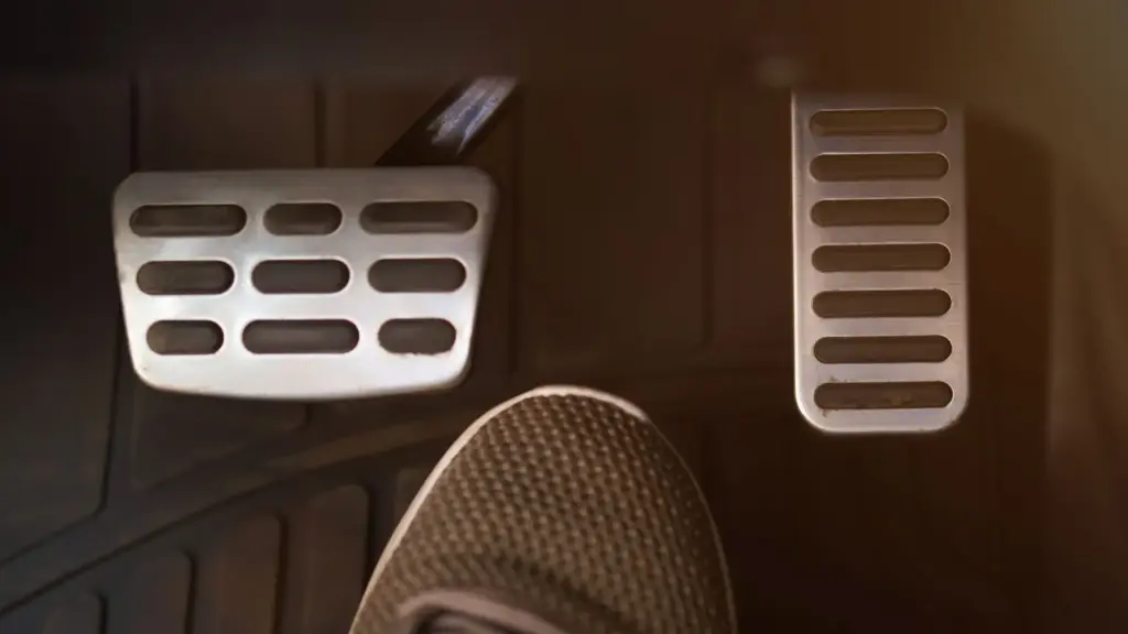 A person with their foot in between the accelerator and brake.