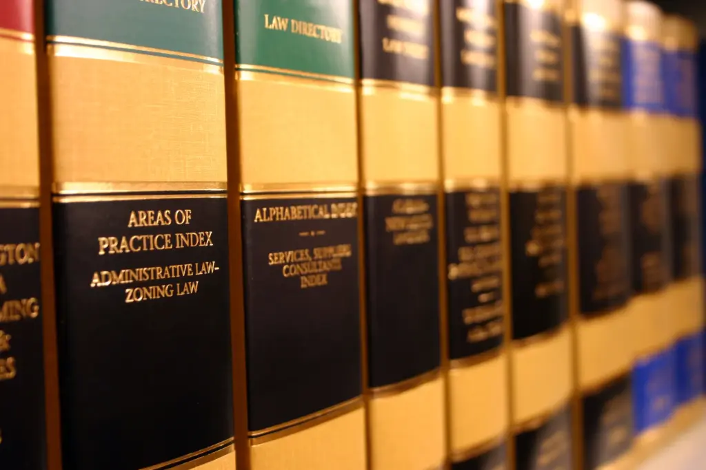 A row of legal books on a bookshelf.