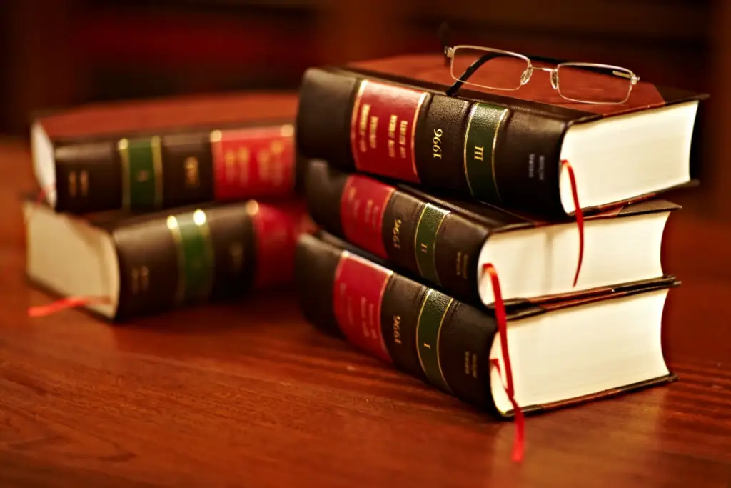 A pile of law books on a table.
