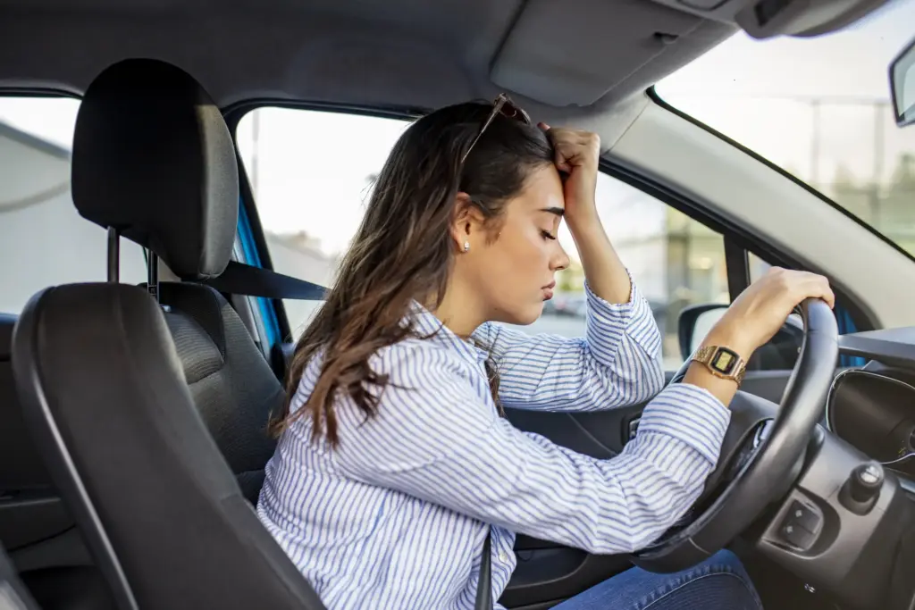 A stressed out driver behind the wheel.