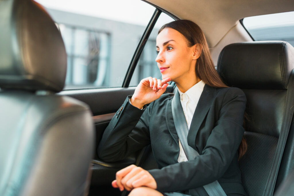 passenger looking through window while traveling by car