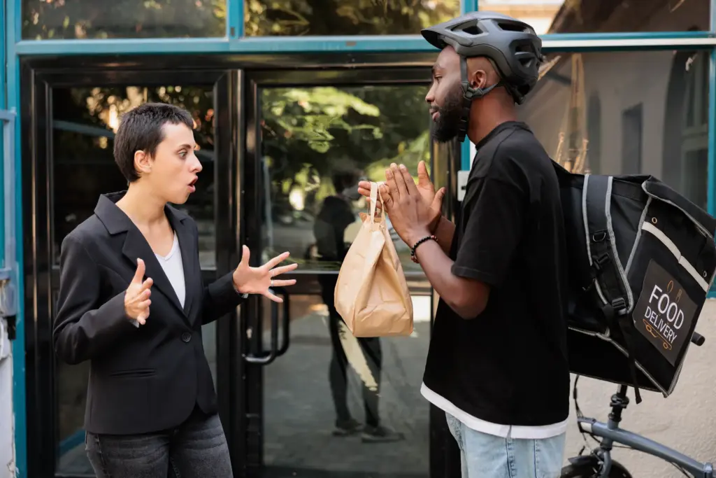 A ubereats delivery biker arguing with a person.