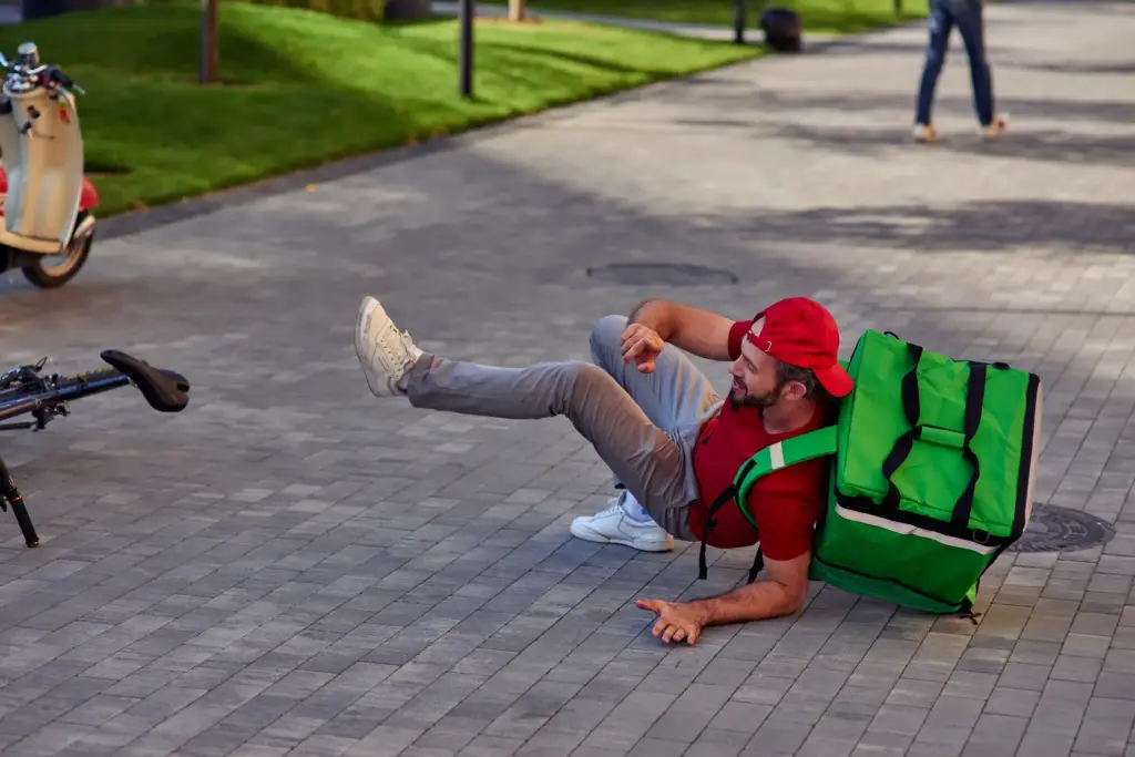A food delivery biker falling.