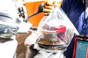 A Ubereats driver delivering food. 