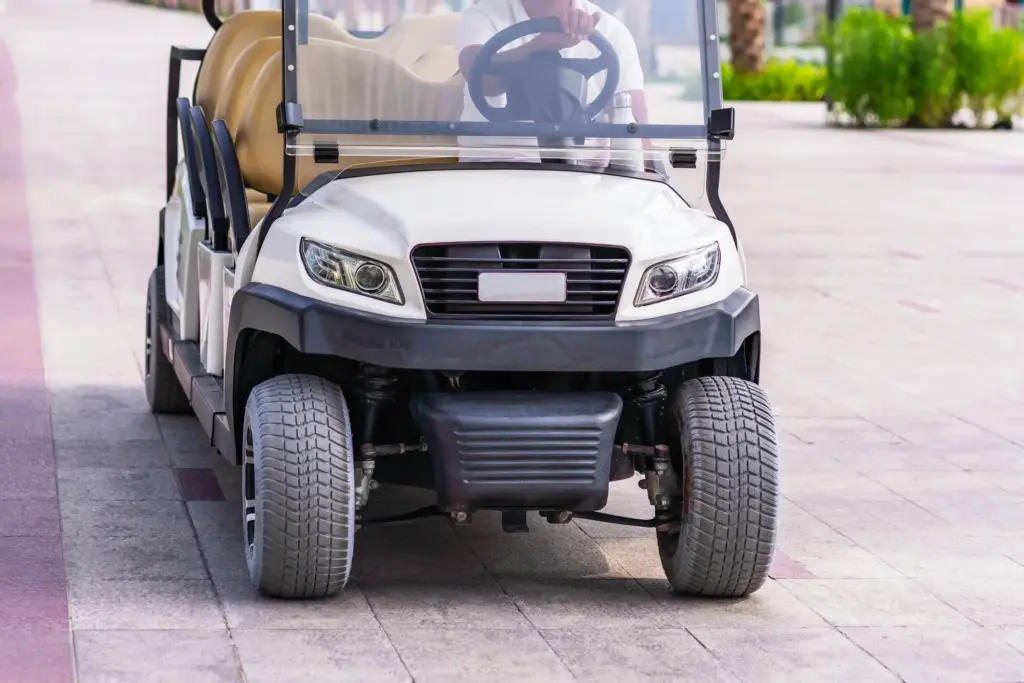 A golf kart driven on a pathway.