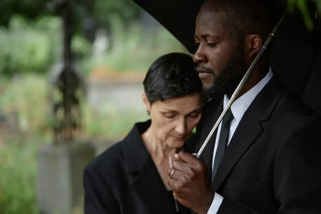 A grieving couple at a funeral.