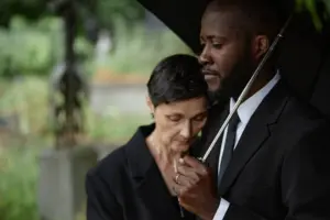 A grieving couple at a funeral.