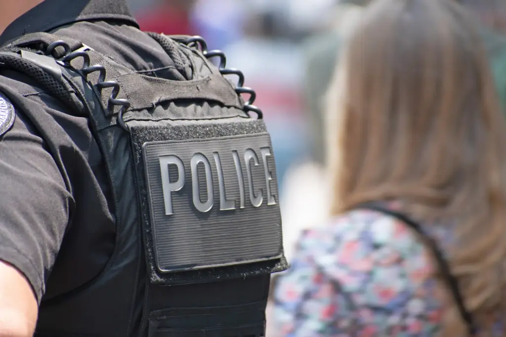 A police officer standing next to a woman.