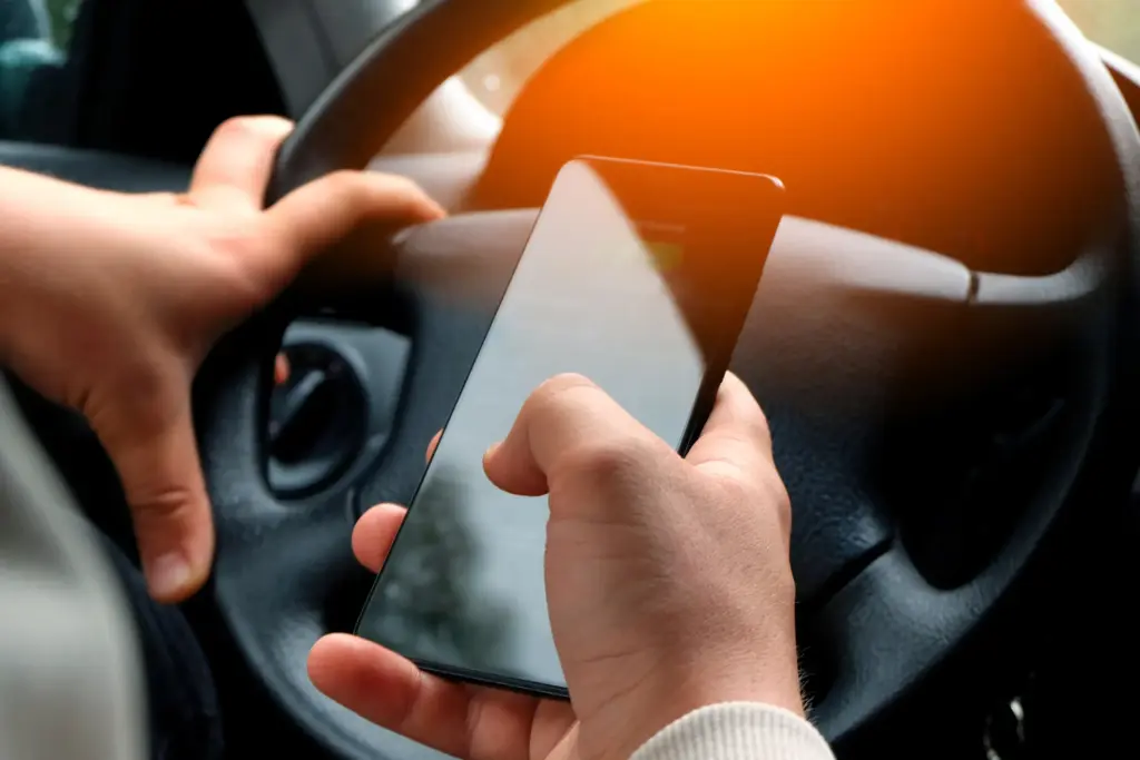 A person texting and driving.
